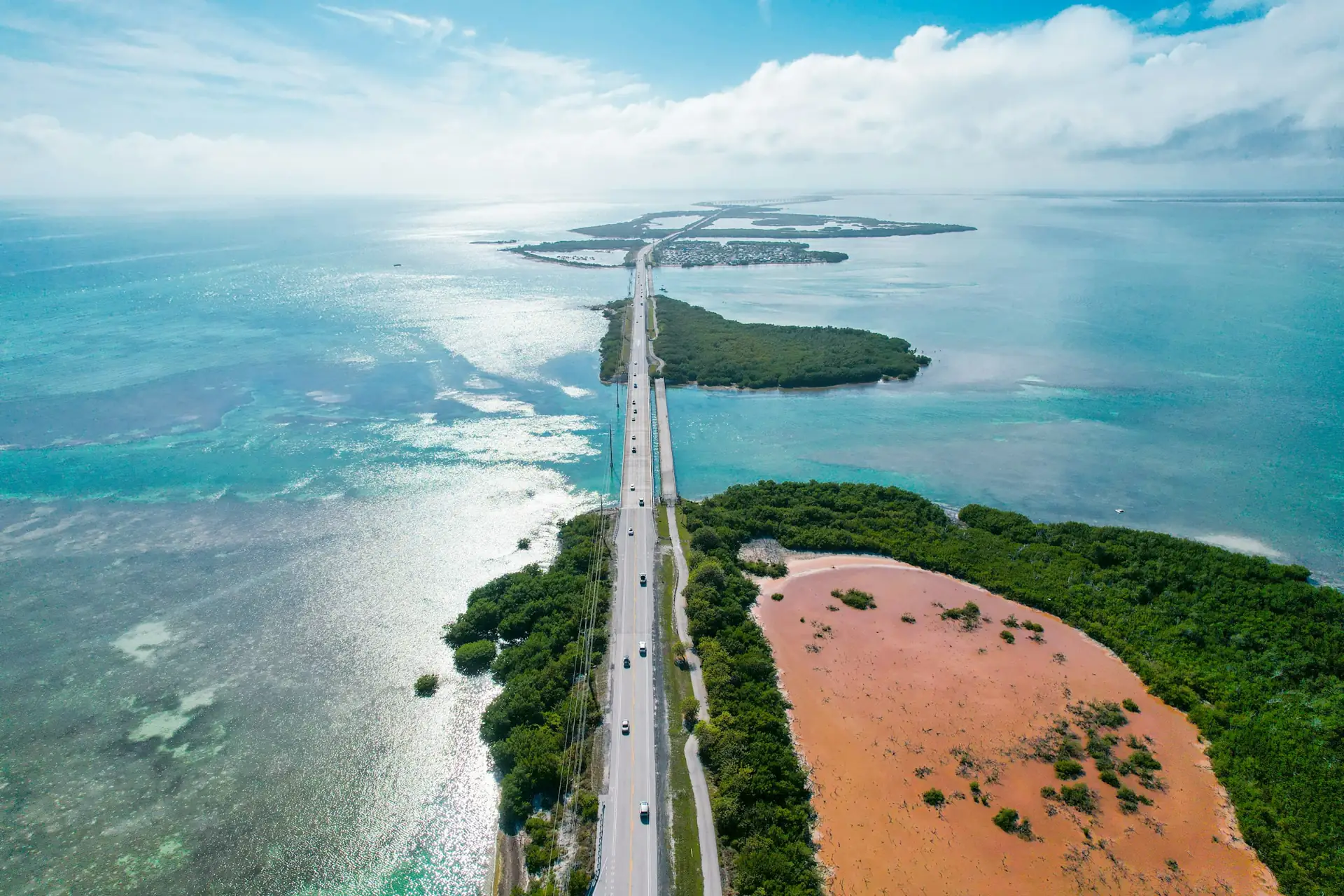 Highway crossing turquoise water between mangrove islands