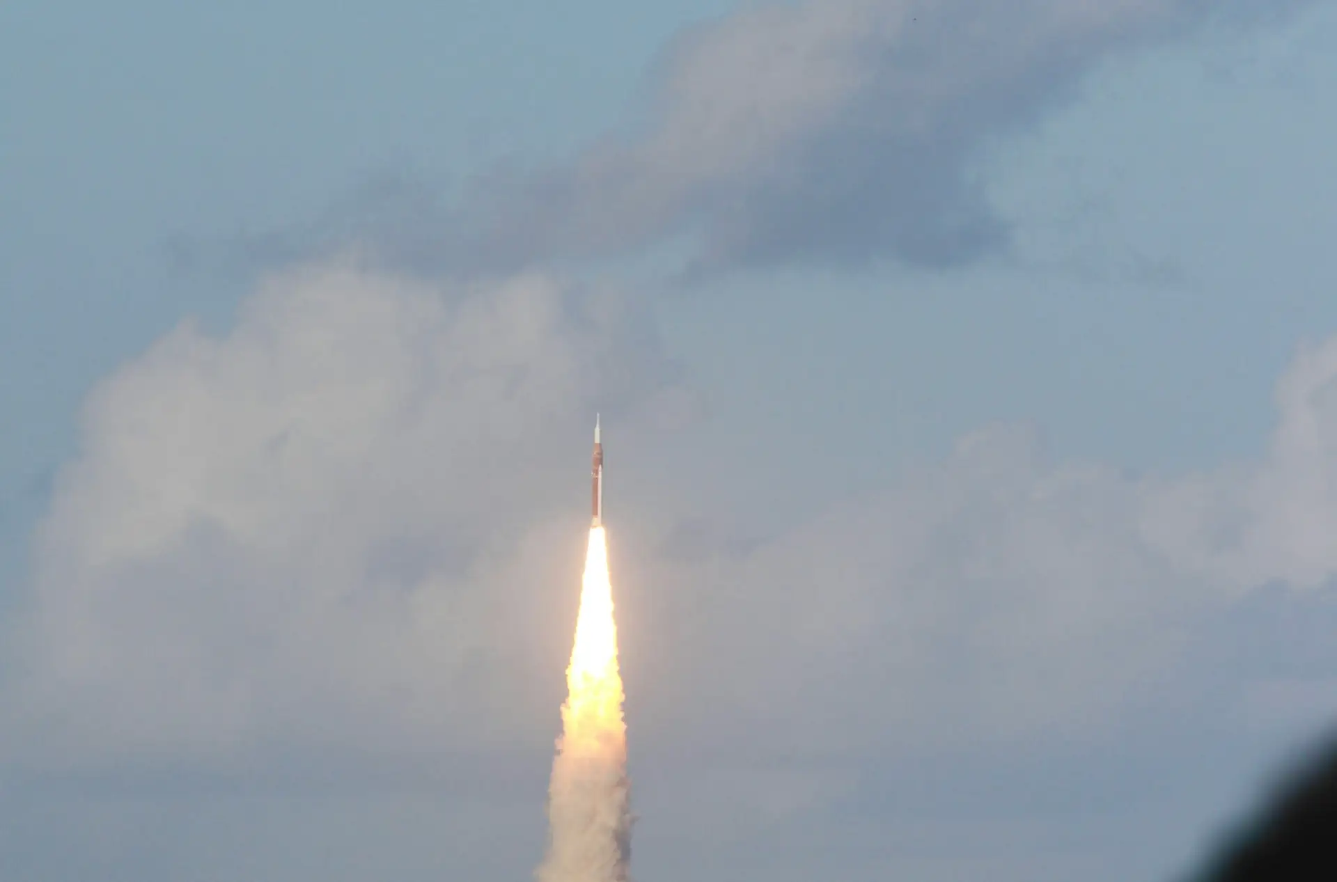 Rocket lifting off above a cloud of exhaust